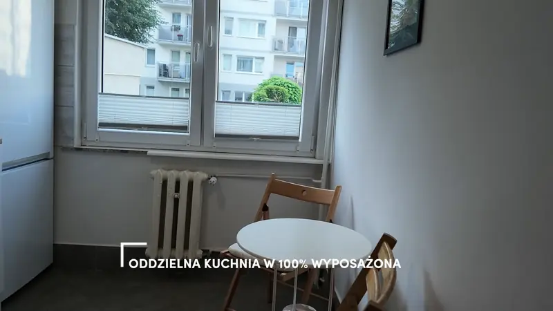 Film still with the caption “Separate, fully equipped kitchen”