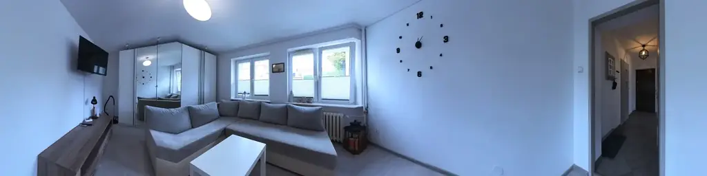 The living room’s 360° panorama unrolled into a strip — Żeromskiego 37